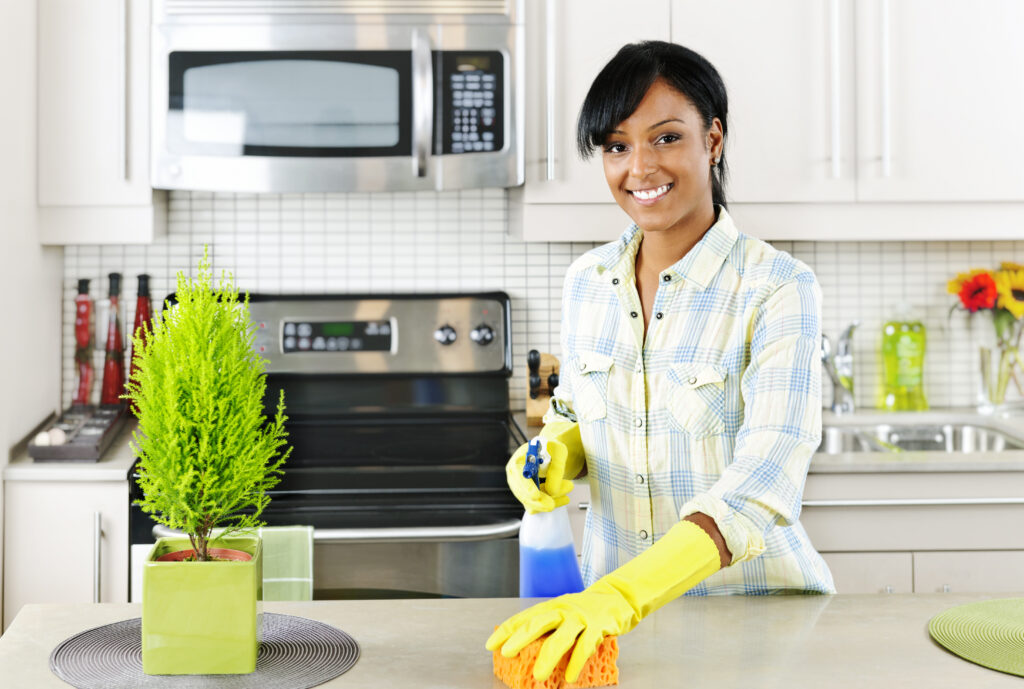 Woman Wiping Down Kitchen Counter